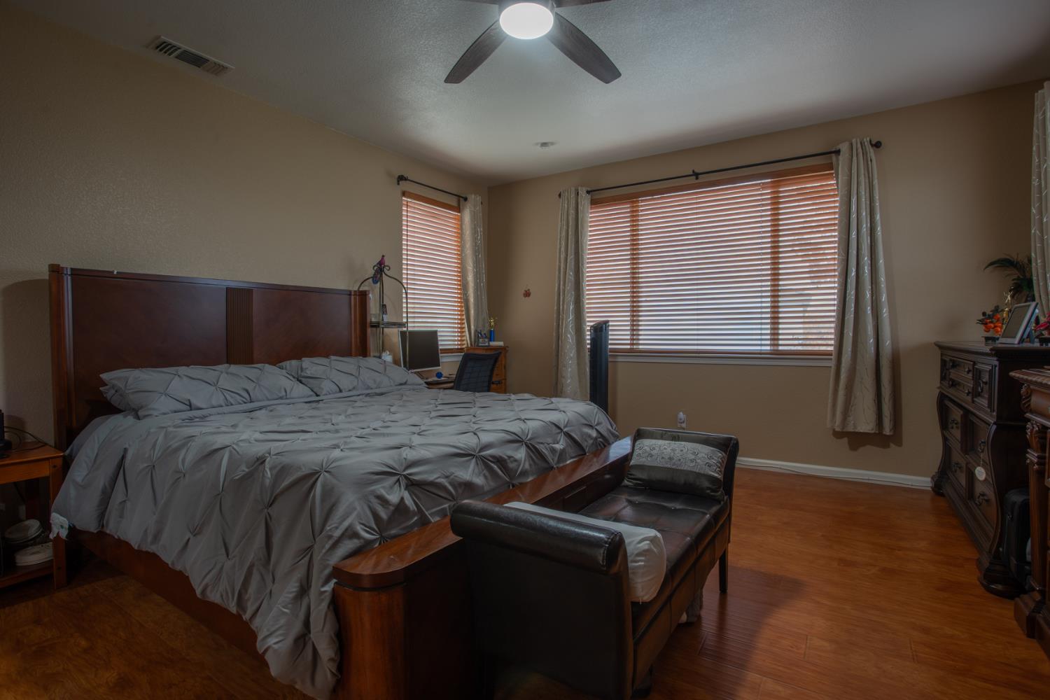 11740 Mani Circle Rancho Cordova, CA 95742 - Photo 42 of 50 a bedroom with a bed and a chandelier