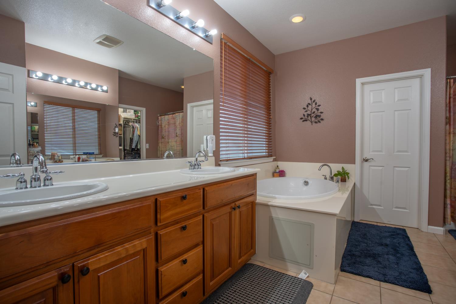 11740 Mani Circle Rancho Cordova, CA 95742 - Photo 43 of 50 a spacious bathroom with a sink a large mirror and a bathtub