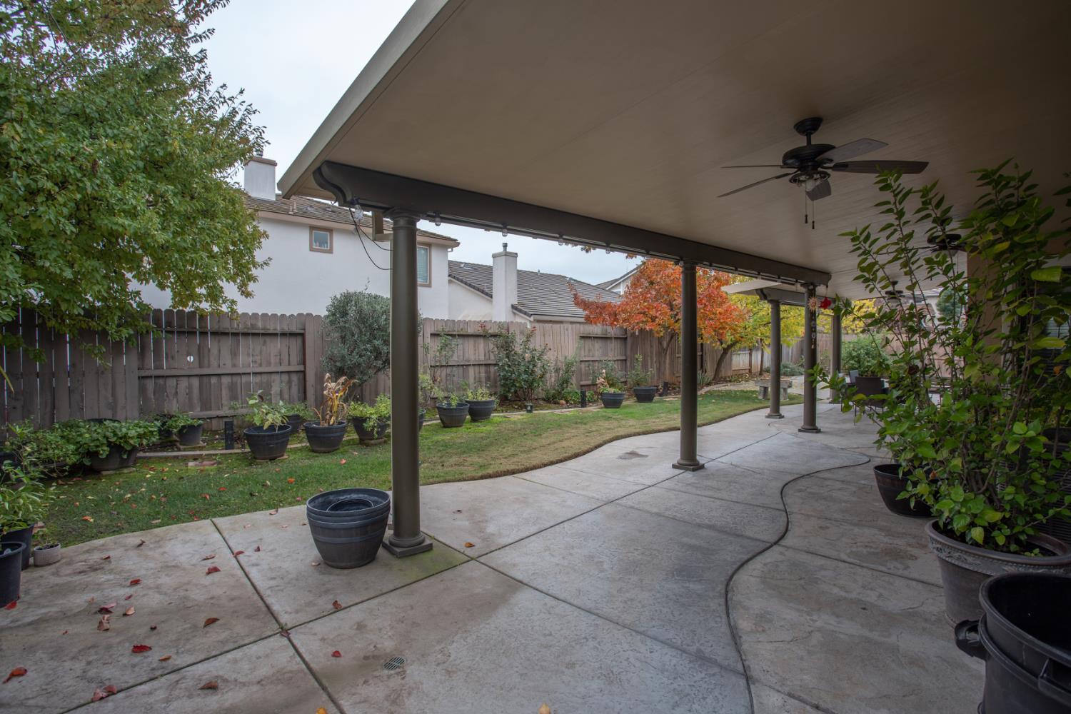 11740 Mani Circle Rancho Cordova, CA 95742 - Photo 49 of 50 a view of a porch with couches and table and chairs under an umbrella