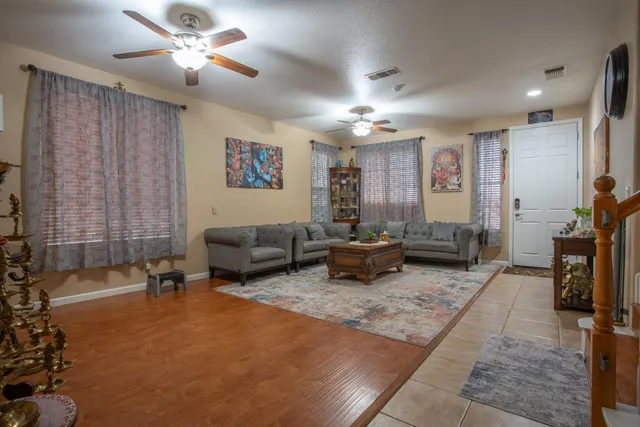 a living room with furniture and a chandelier