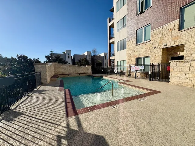 a view of a balcony with chairs and wooden fence