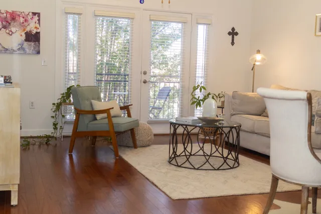 a living room with furniture a table and a large window