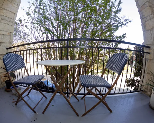 a view of a chairs and table in patio