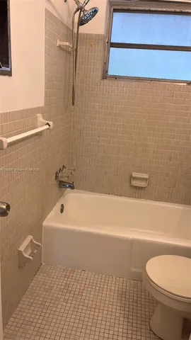 a bathroom with a toilet a sink and bathtub