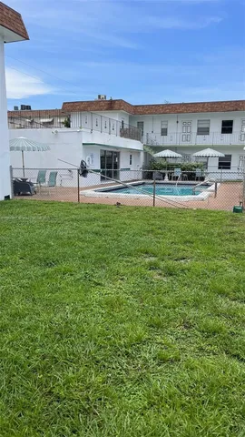 a view of a swimming pool with lawn chairs
