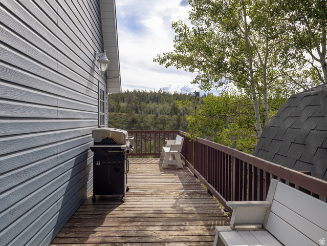 4770 Pine Crest Road Evanston, UT 82930 - Photo 4 of 24 Spacious outdoor deck with wood flooring and a brown railing