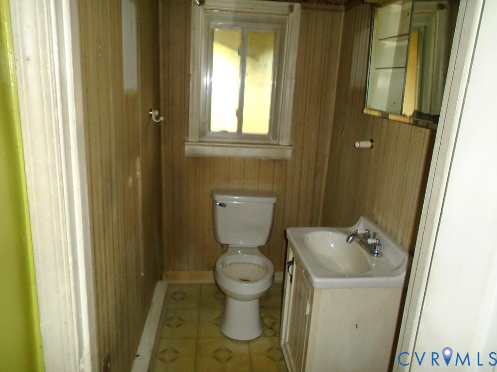 16203 West Patrick Henry Road Montpelier, VA 23192 - Photo 19 of 23 Compact bathroom featuring a window, toilet, vanit
