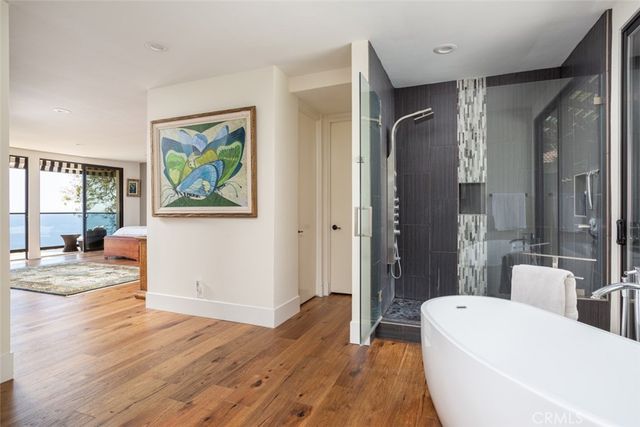 a bedroom with a bed a large window and a book shelf