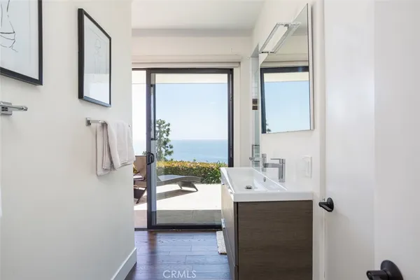 a bedroom with a bed a large window and book shelf