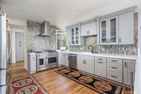 a kitchen with a sink stove and cabinets
