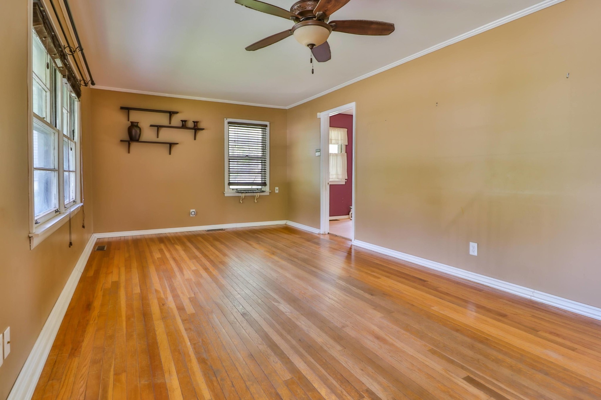 103 South Seneca Road Oak Ridge, TN 37830 - Photo 12 of 26 a view of an empty room with wooden floor and a window
