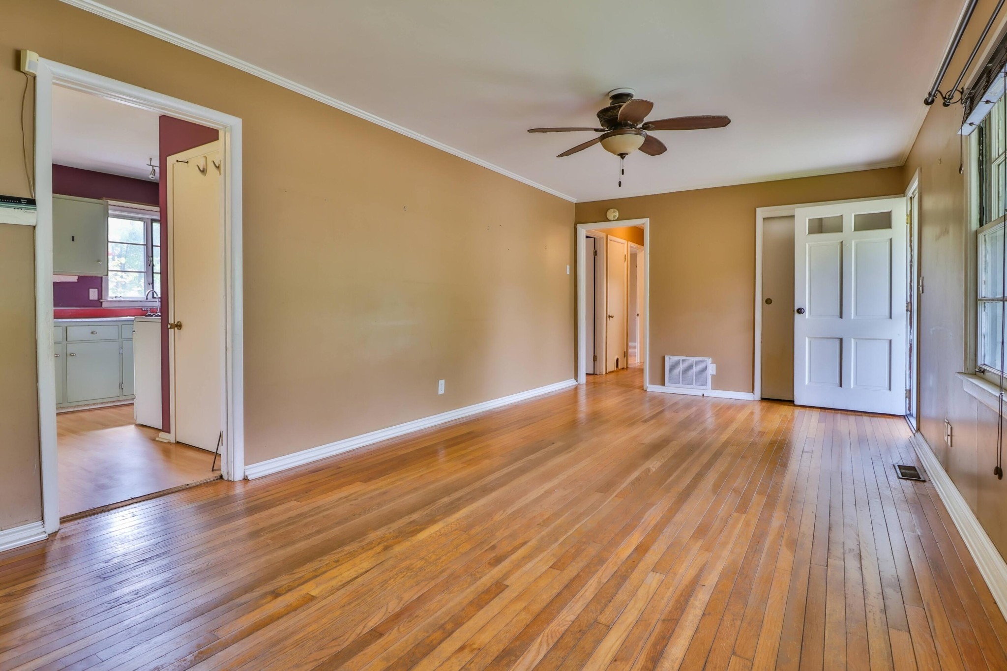 103 South Seneca Road Oak Ridge, TN 37830 - Photo 13 of 26 a view of a room with wooden floor a ceiling fan and windows