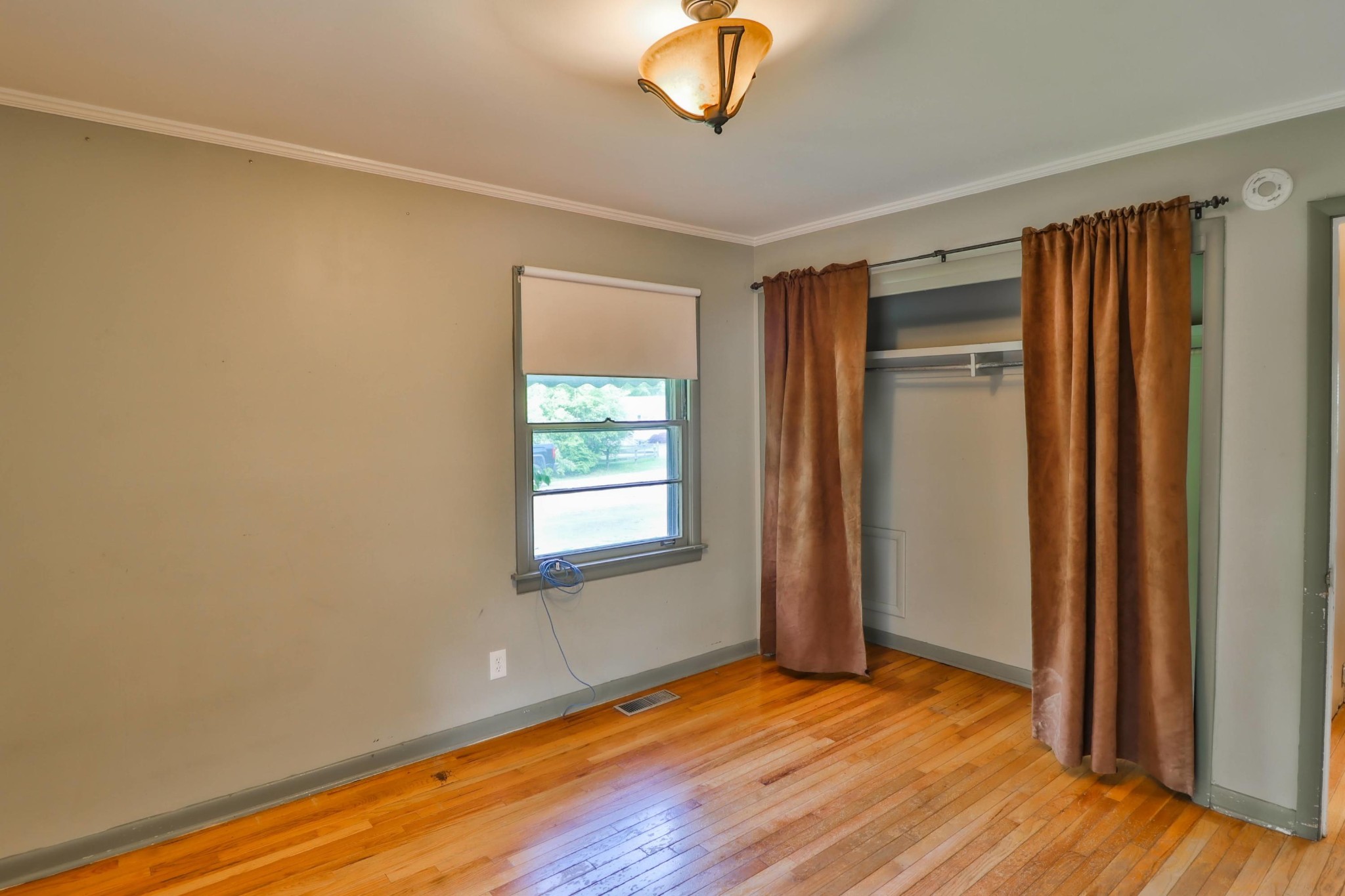 103 South Seneca Road Oak Ridge, TN 37830 - Photo 17 of 26 a view of an empty room with wooden floor and a window