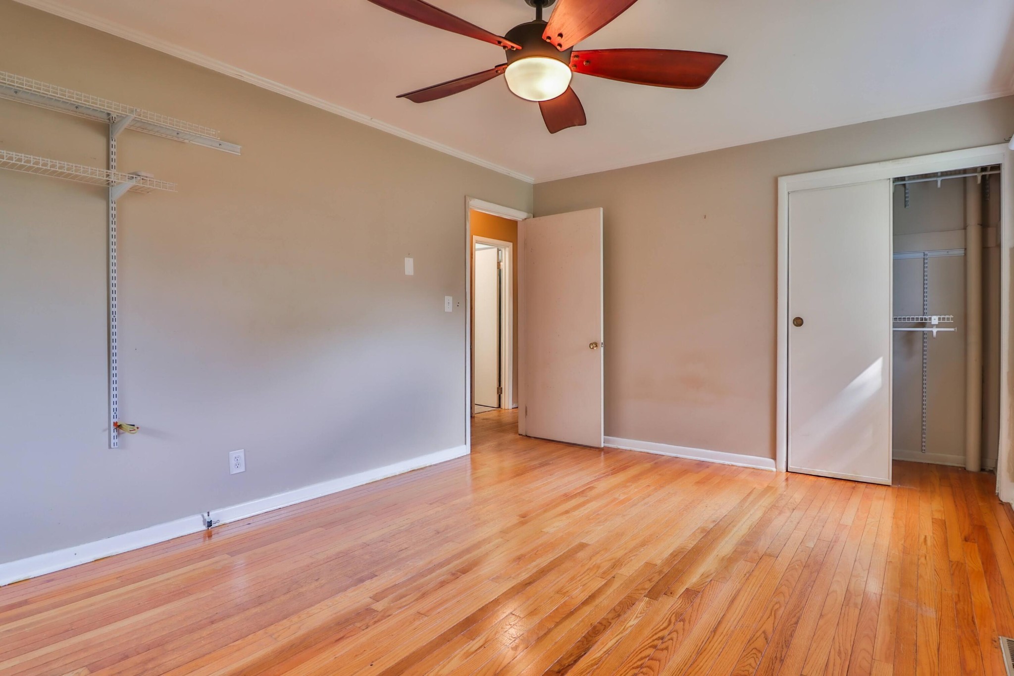 103 South Seneca Road Oak Ridge, TN 37830 - Photo 19 of 26 a view of an empty room with wooden floor and a ceiling fan