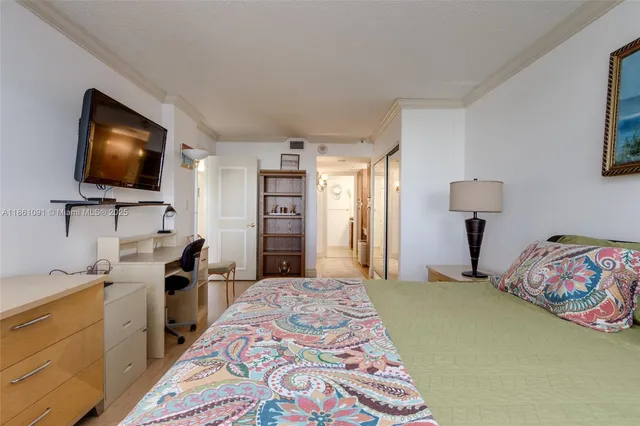 a bedroom with a bed and flat screen tv