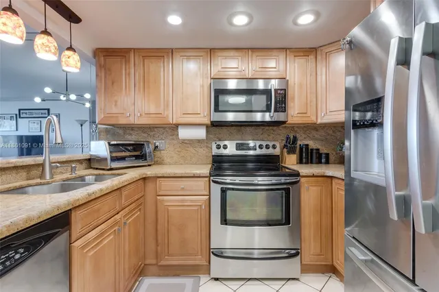 a kitchen with a sink stove and microwave