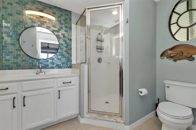 a bathroom with a granite countertop sink mirror and toilet