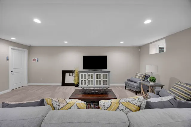 a living room with furniture and a large window