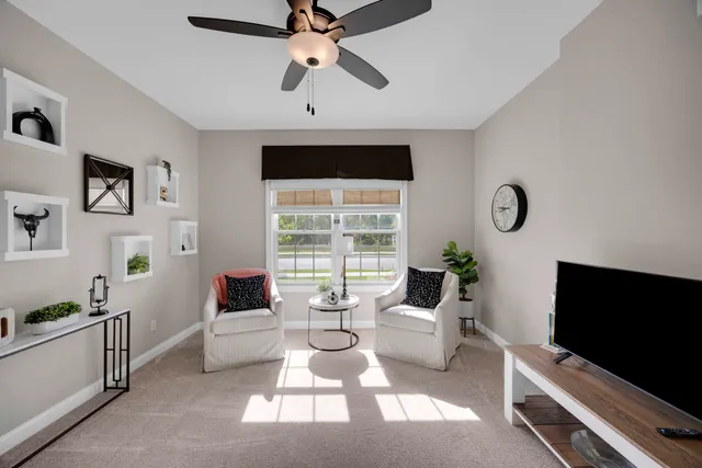 a living room with furniture a rug and a flat screen tv