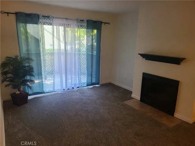 an empty room with wooden floor and a window