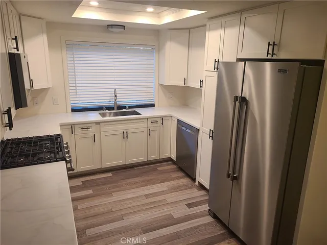 a kitchen with cabinets appliances and a sink