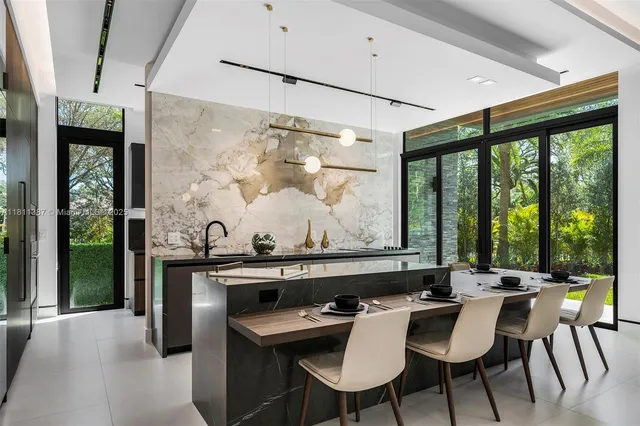 a view of a dining room with furniture large windows and wooden floor