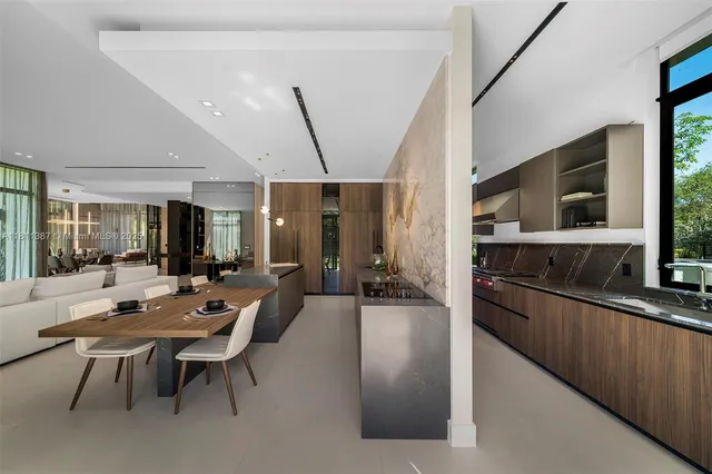 a large kitchen with a table and chairs