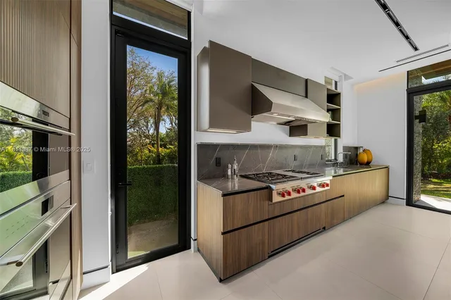 a kitchen with stainless steel appliances granite countertop a stove and a refrigerator