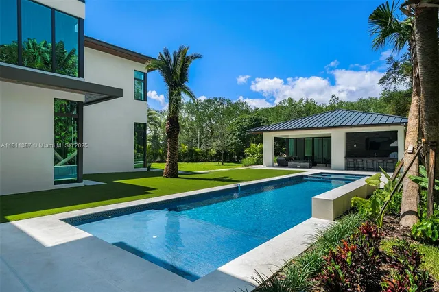 a living room with furniture and a floor to ceiling window