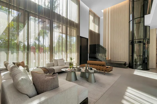 a living room with furniture and large windows