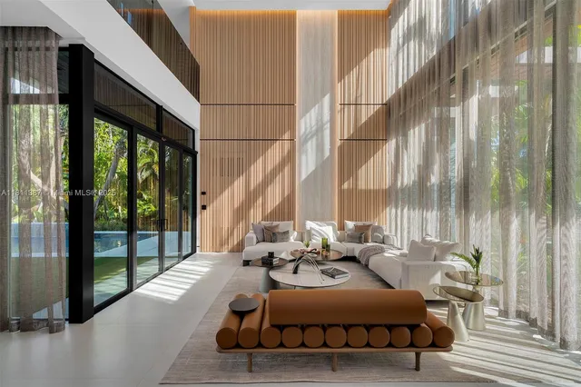 a bedroom with furniture and large windows