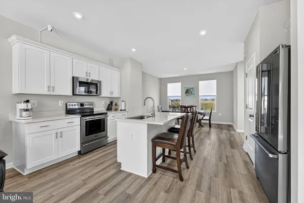 a living room with furniture and kitchen view