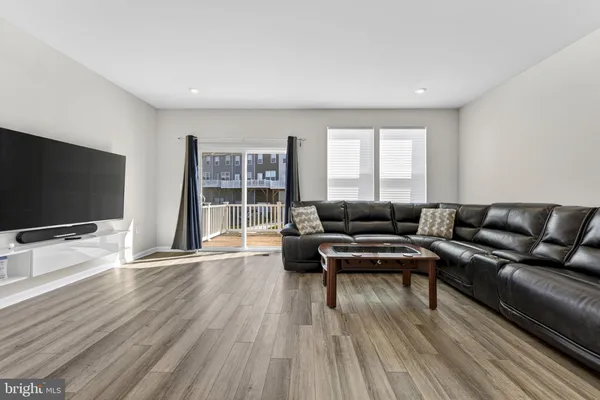 a living room with furniture and kitchen view