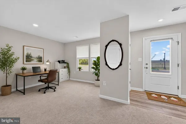 a view of a livingroom with furniture and a potted plant