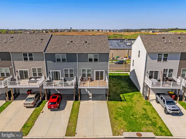 a aerial view of a brick house next to a yard