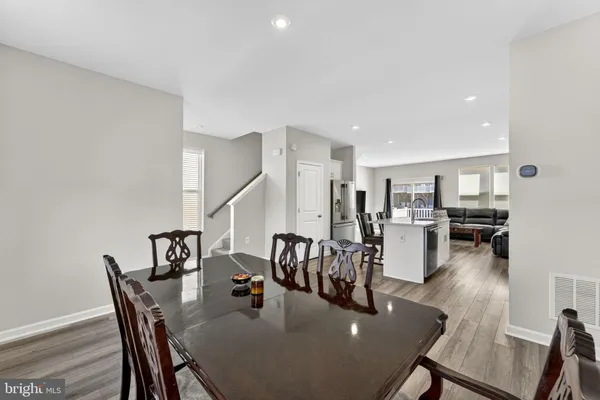 a dining room with furniture and wooden floor