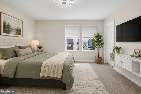 a bedroom with a large bed and a flat screen tv