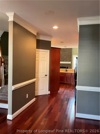 a view of a kitchen with furniture and wooden floor