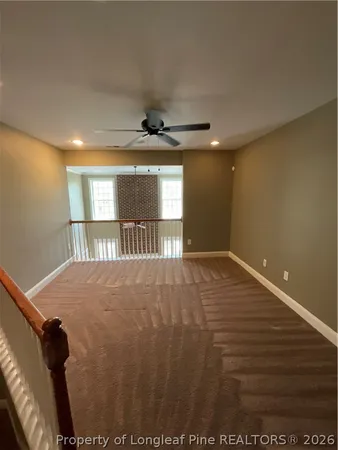 a view of a livingroom with wooden floor and a window