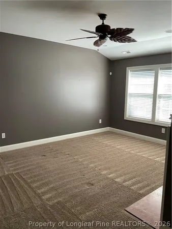 a view of a livingroom with wooden floor and a fireplace