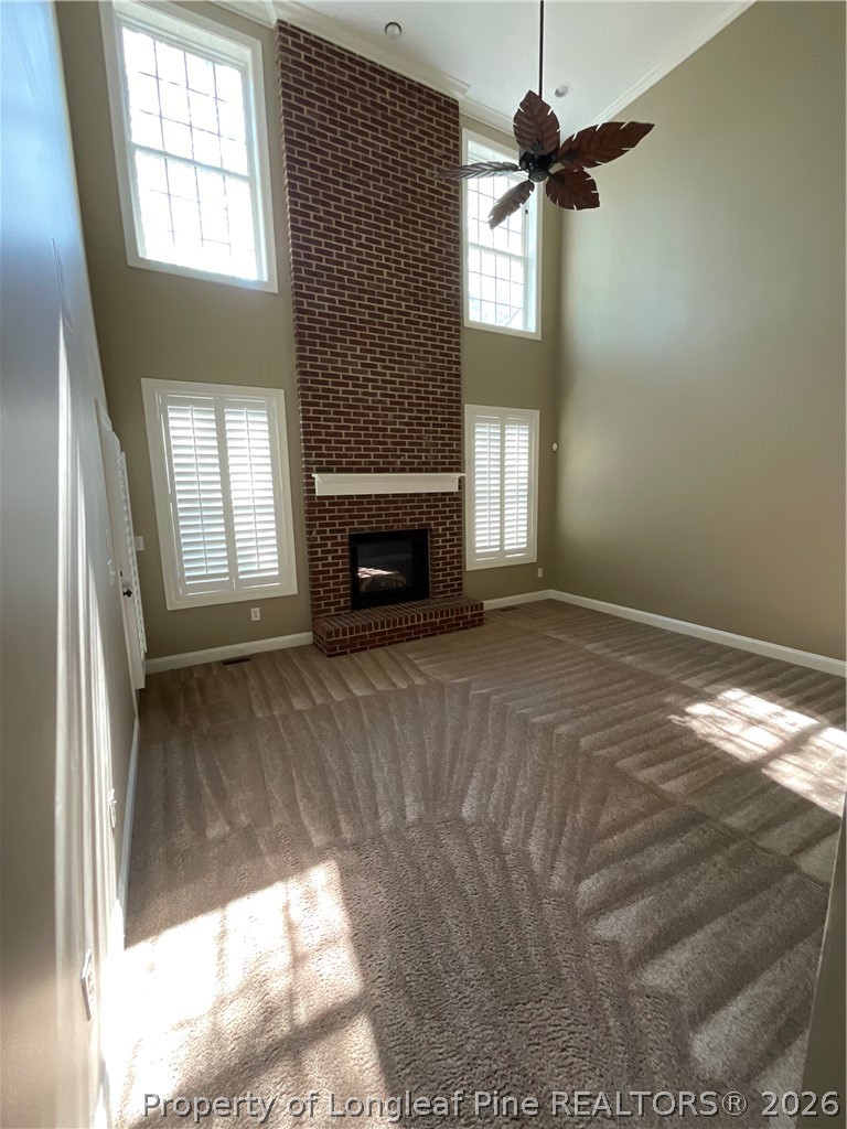 67 Hawk Ridge Drive Spring Lake, NC 28390 - Photo 4 of 32 a view of empty room with fireplace and windows