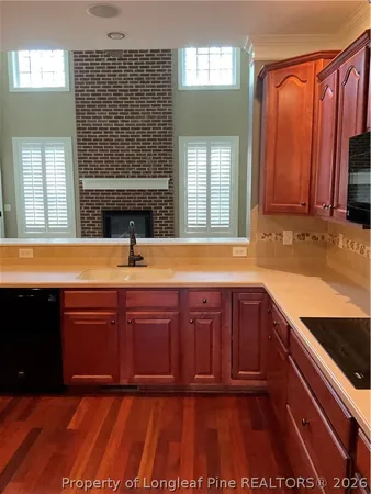 a kitchen with stainless steel appliances granite countertop wooden cabinets a sink and dishwasher