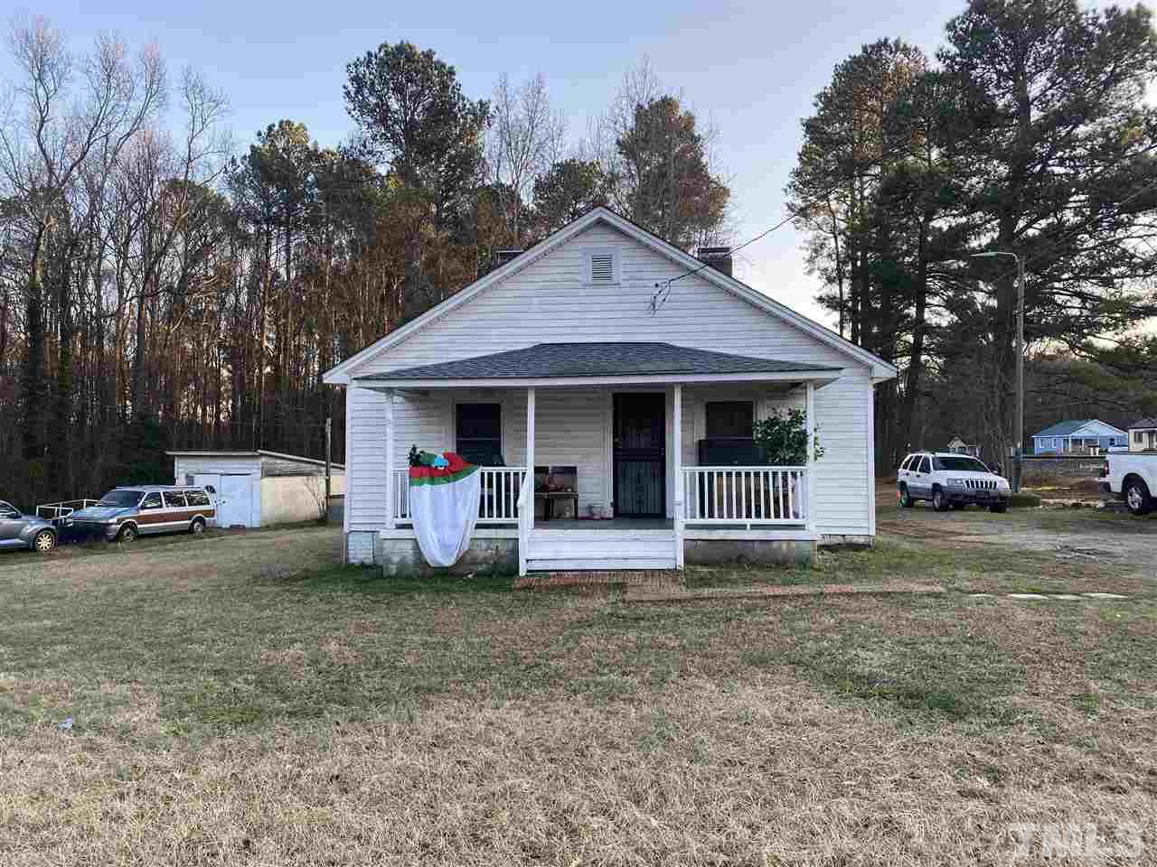 2304 Ferrell Road Durham, NC 27704 - Photo 1 of 6 a front view of a house with a garden and porch