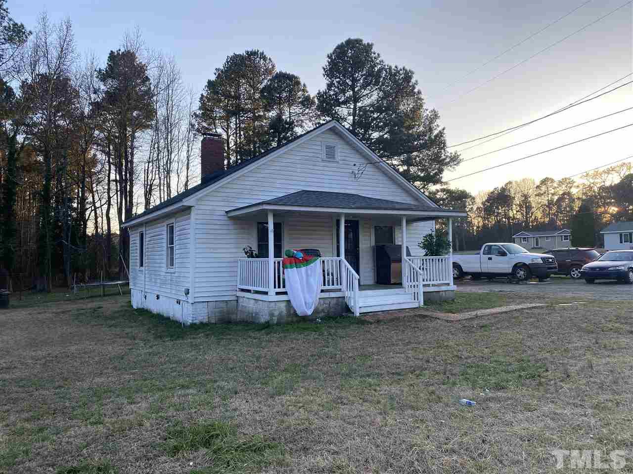 2304 Ferrell Road Durham, NC 27704 - Photo 3 of 6 a front view of a house with a garden and parking space