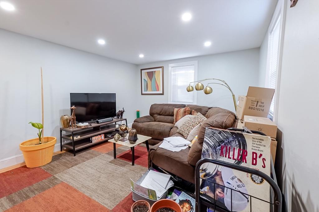 5 Oliver Street Randolph, MA 02368 - Photo 18 of 29 a living room with furniture and a flat screen tv