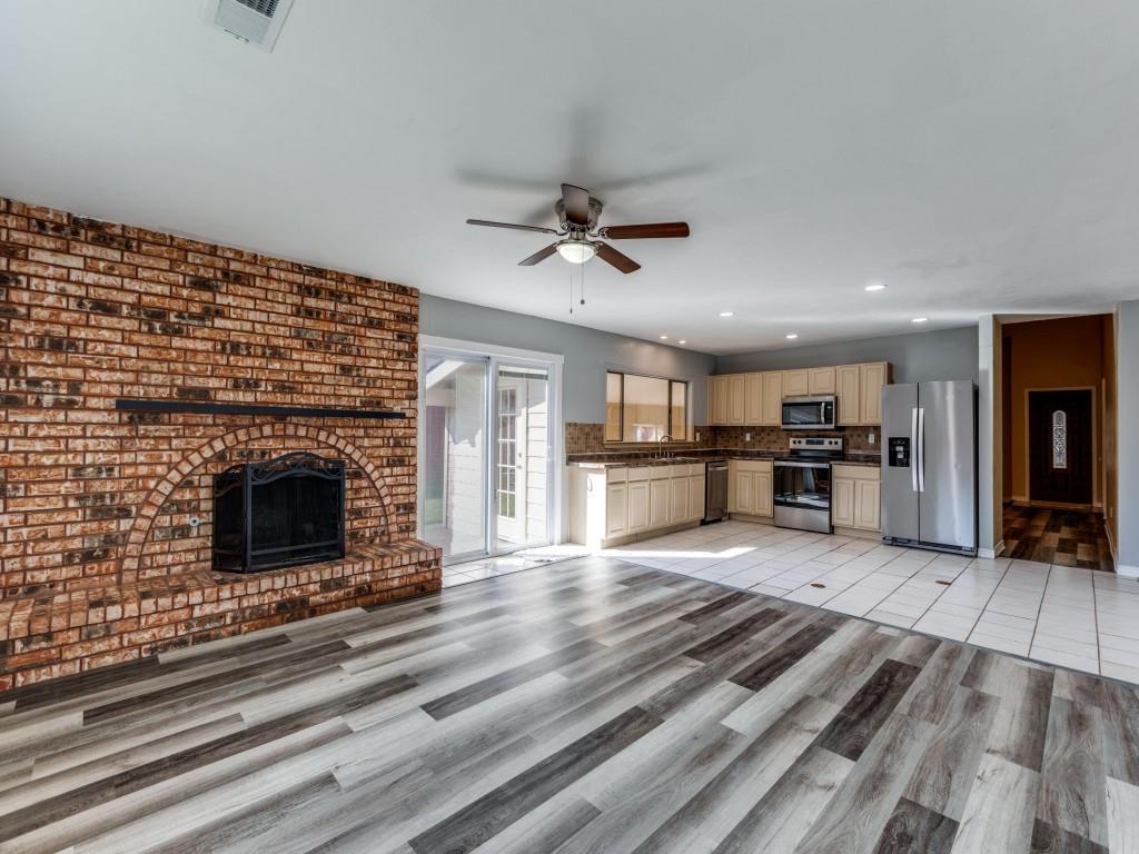 1709 Canadian Trail Plano, TX 75023 - Photo 2 of 12 a living room with stainless steel appliances kitchen island granite countertop furniture and a fireplace