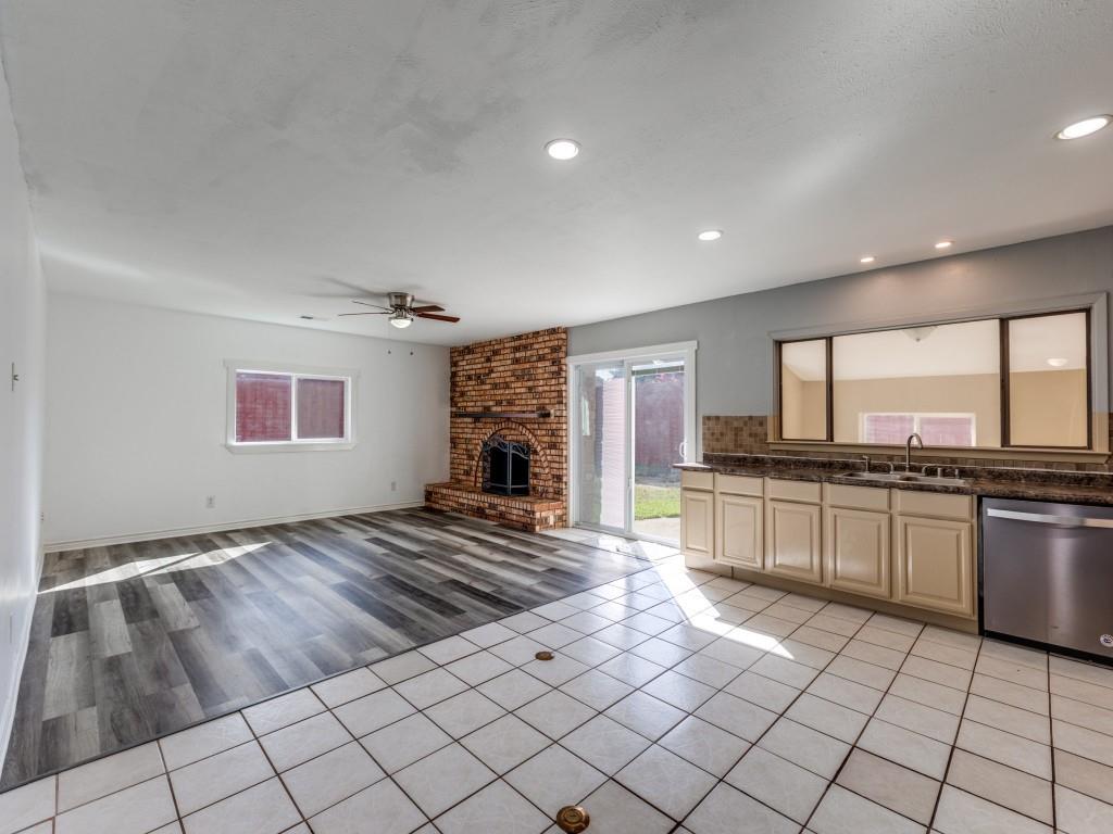 1709 Canadian Trail Plano, TX 75023 - Photo 3 of 12 a large kitchen with kitchen island granite countertop a sink and a stove top oven