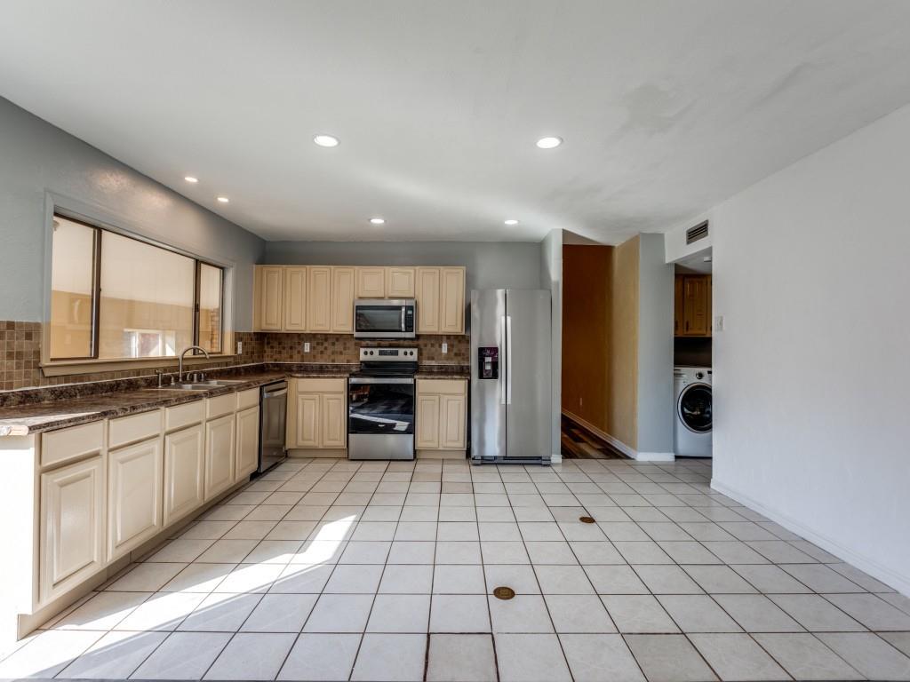 1709 Canadian Trail Plano, TX 75023 - Photo 4 of 12 a large kitchen with a large window and stainless steel appliances