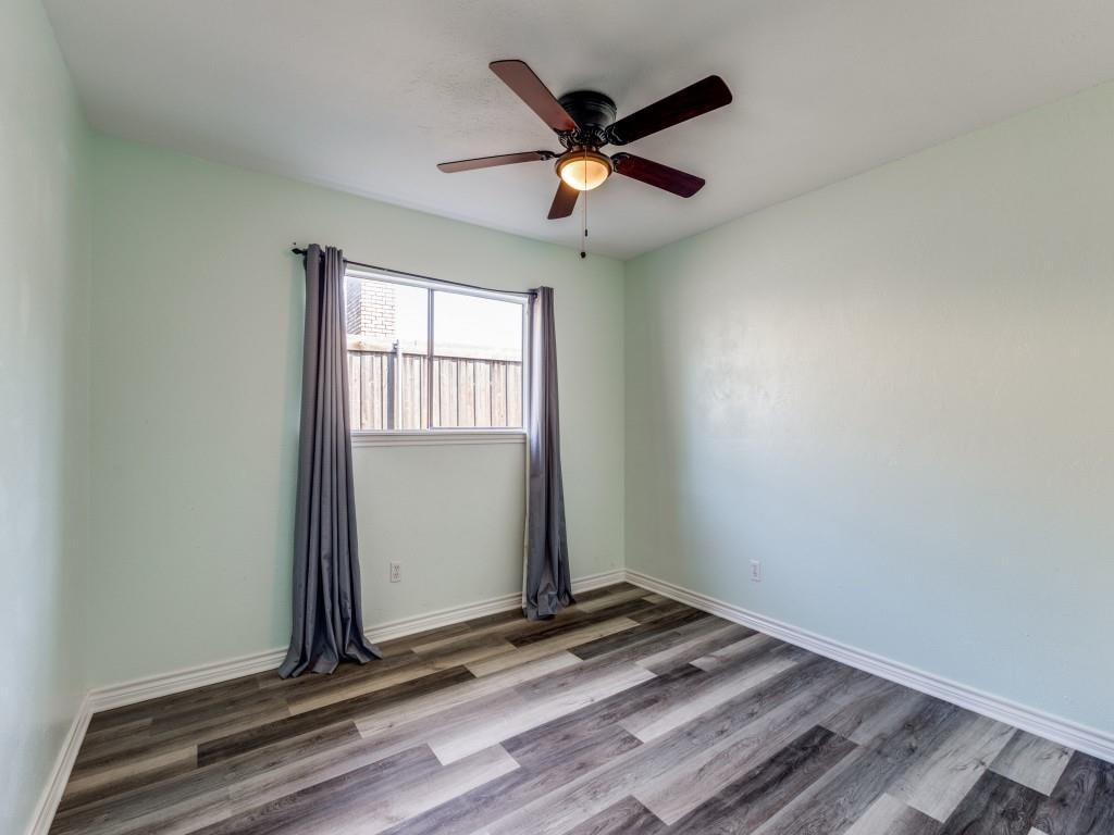 1709 Canadian Trail Plano, TX 75023 - Photo 7 of 12 an empty room with wooden floor and windows