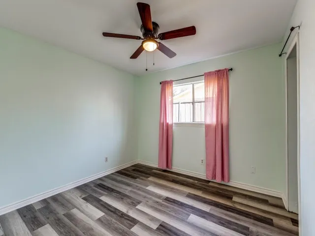 a view of a room with a ceiling fan